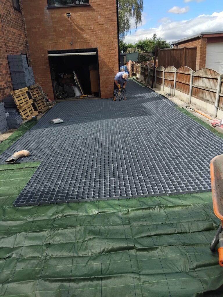 Groundwork contractor installing plastic grids