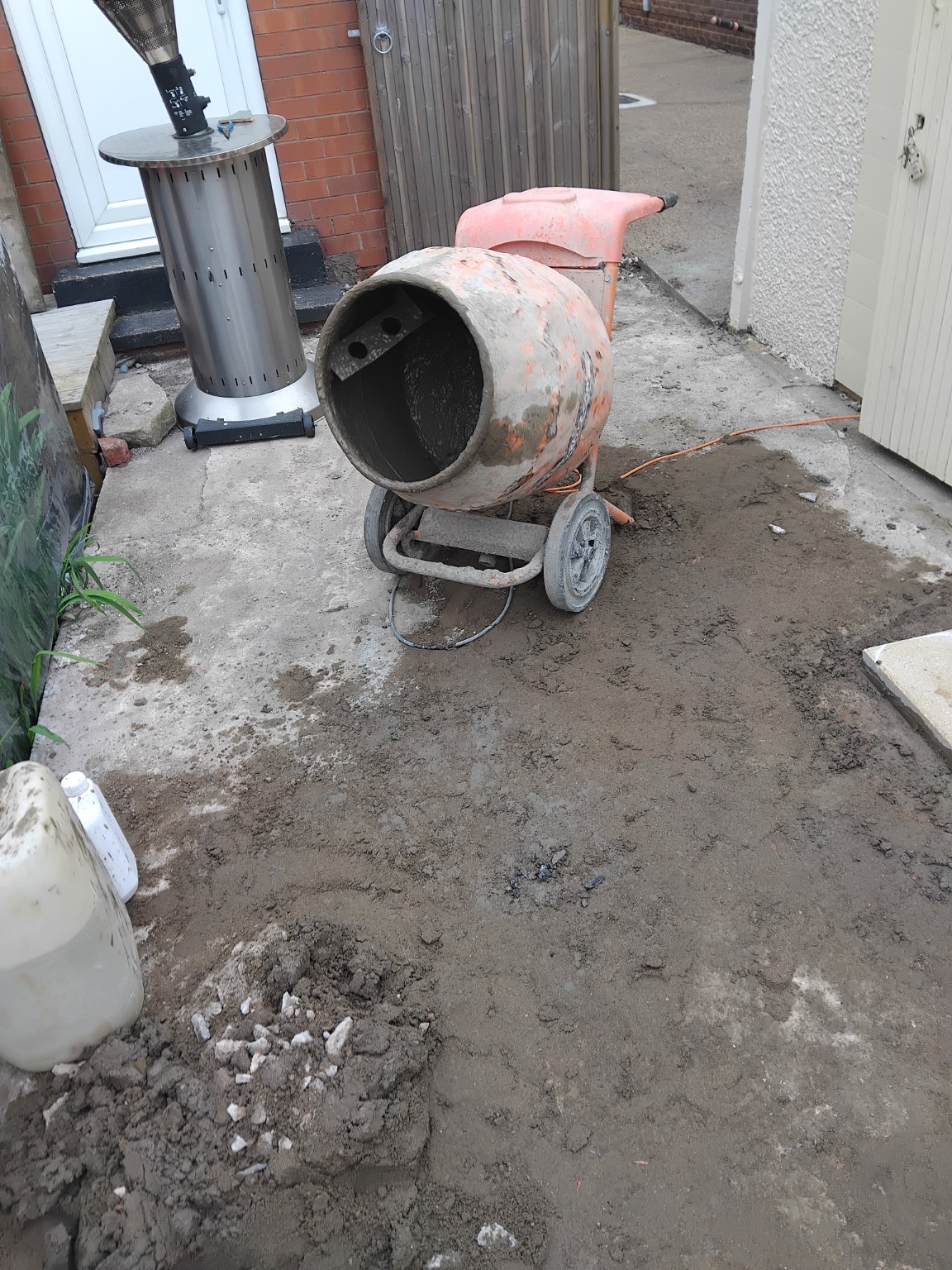 Patio preparation area with a cement mixer before laying paving slabs