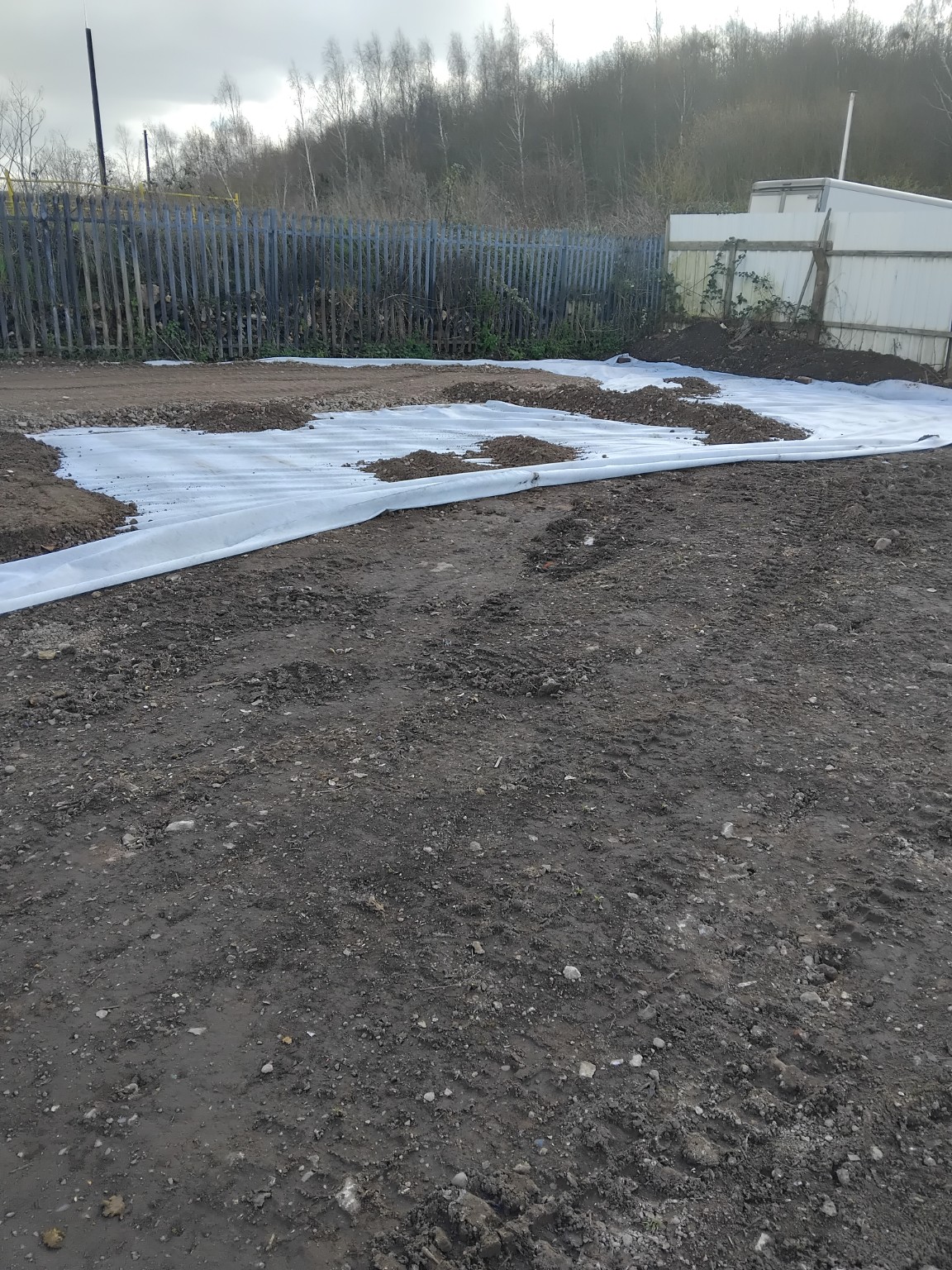 Ground membrane being laid across the prepared container storage site