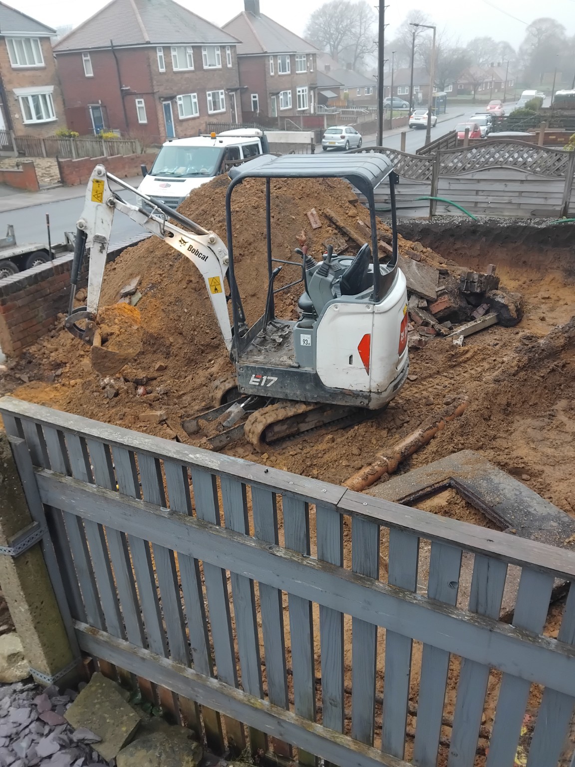 Mini excavator working within the lowered front garden