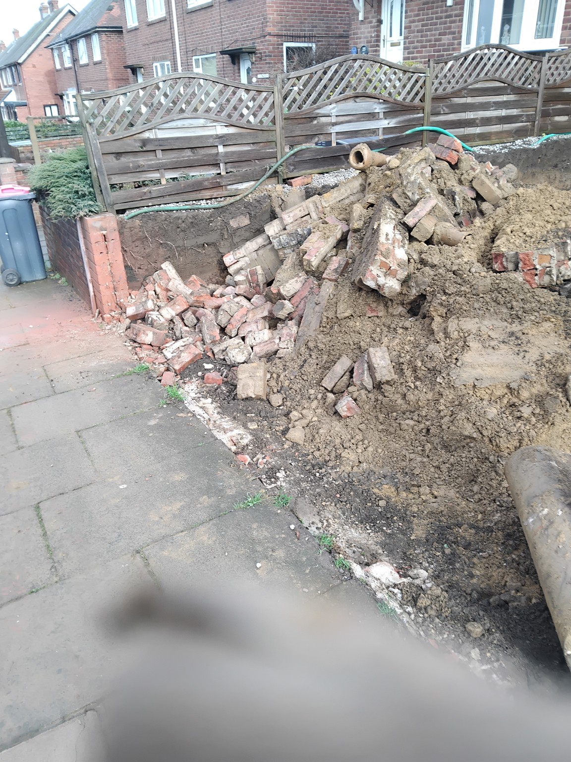 Old brick boundary wall being removed during site clearance