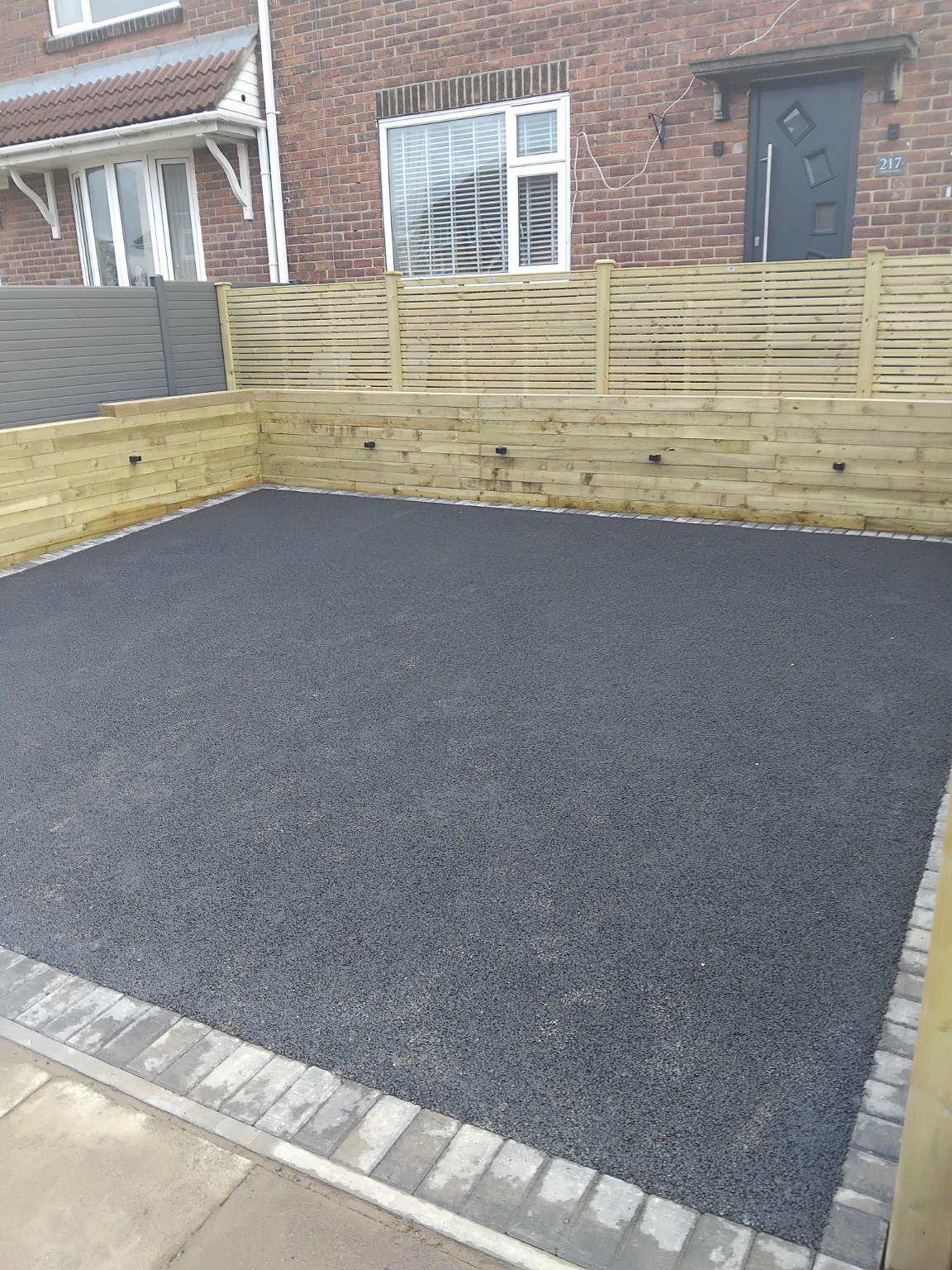 Completed driveway surface inside the timber retaining walls