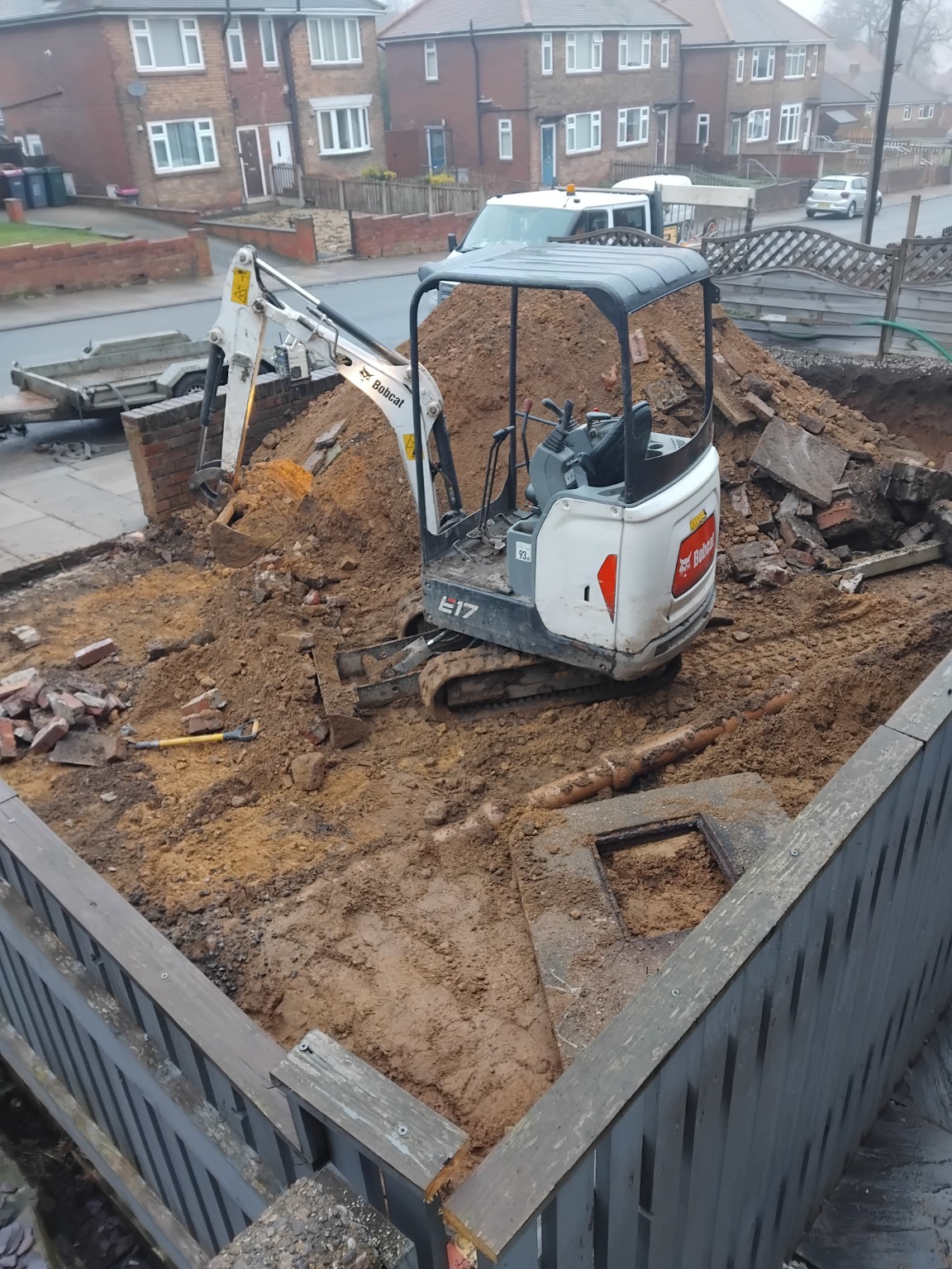 Mini excavator working on an excavated residential site