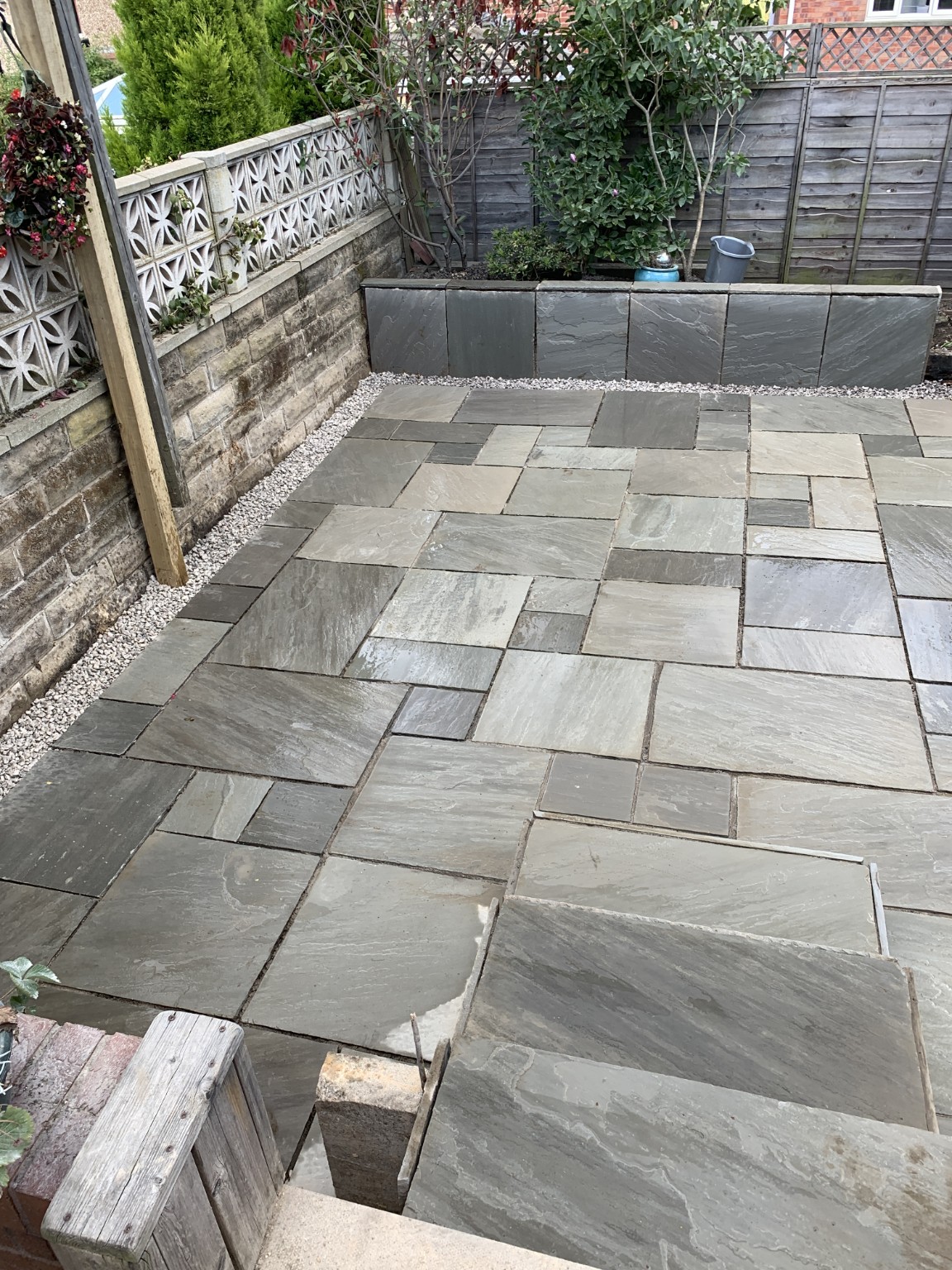 Natural stone garden paving with steps and raised borders